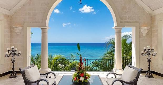 Luxury villa interior opening onto an ocean-view terrace