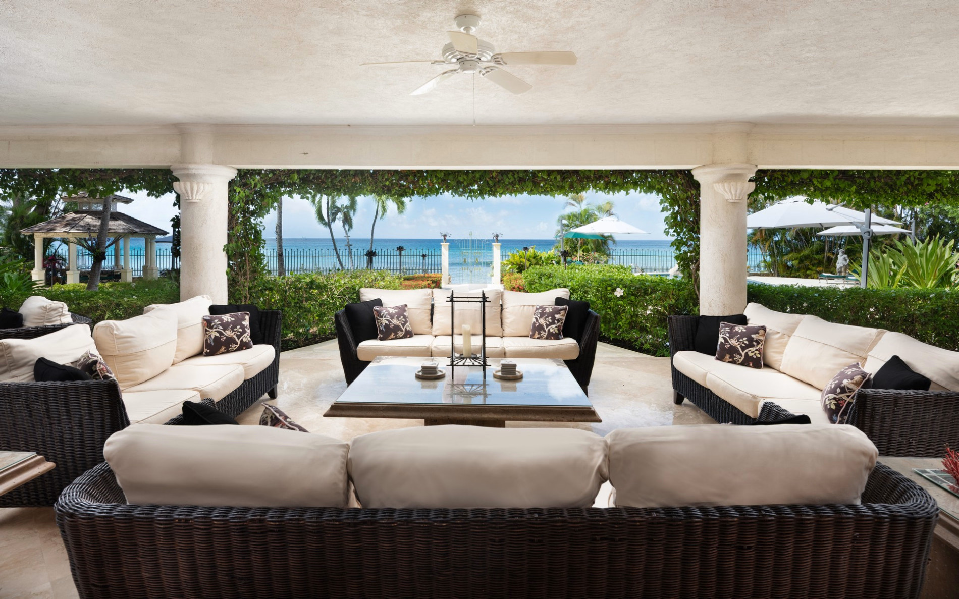 A shaded Barbados villa veranda overlooking the Caribbean Sea